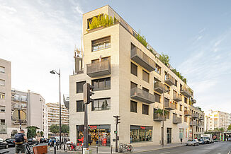 Mixed-use building in Paris with supermarket and flats.