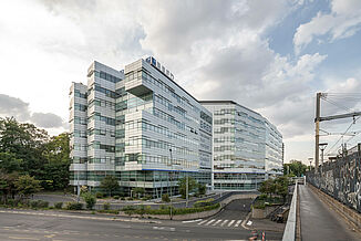 A BRED Bank building with a glass façade was built directly on the railway tracks in Joinville-le-Pont Paris.
