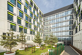 Building of the paediatric hospital of the university clinic in Warsaw with green area and playground.