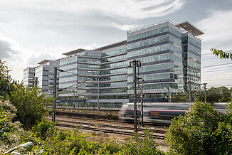 West Plaza office complex in Colombes with passing train.