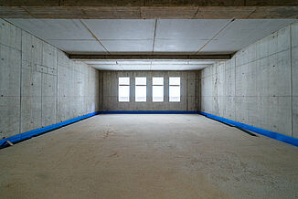 Room-in-room constructions in the rehearsal hall at the Haus der Musik in Siegen.
