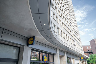 A mixed-use building in Paris with a Lidl on the ground floor and flats above.