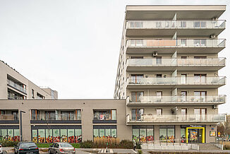 Entrance to the Biedronka supermarket in Warsaw in a mixed-use building with residential units above the supermarket.