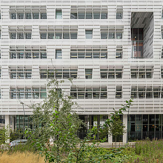 Bright façade with many windows of the building complex of the Conseil Régional of the Île de France region in Paris.