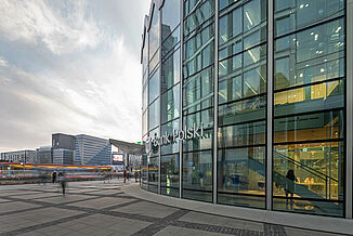 Bank Polski in the Rotunda mixed-use building in Warsaw with a view of other residential and commercial buildings and the street.