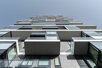 Detailed view of the façade of the Henninger Turm in Frankfurt with balconies.