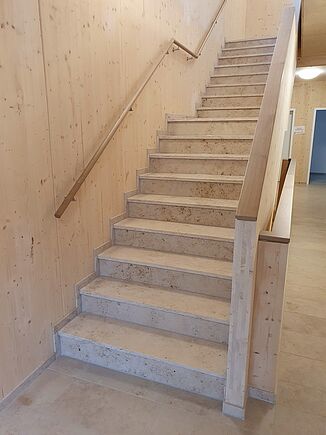 Light-coloured wooden surfaces in the stairwell of a retirement home in Kümmersbruck.