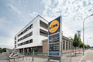 Mixed-use building with a Lidl supermarket, flats and a playground.