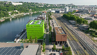 Aerial view of the MOB Hotel with directly adjacent railway tracks in Lyon and view of the city.