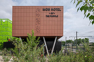 Exterior view of the modern MOB Hotel in Lyon, which is located directly on the railway infrastructure.