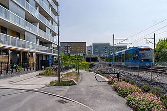 train passing building complex with balconies