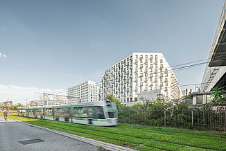 Mixed-use building Rosa Park in Paris with passing tram.