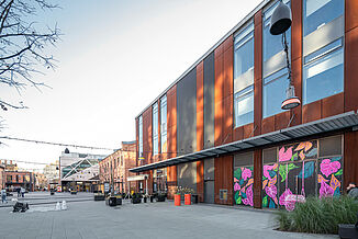 Brick and steel façades of the mixed-use Koneser building in Warsaw's Praga district.