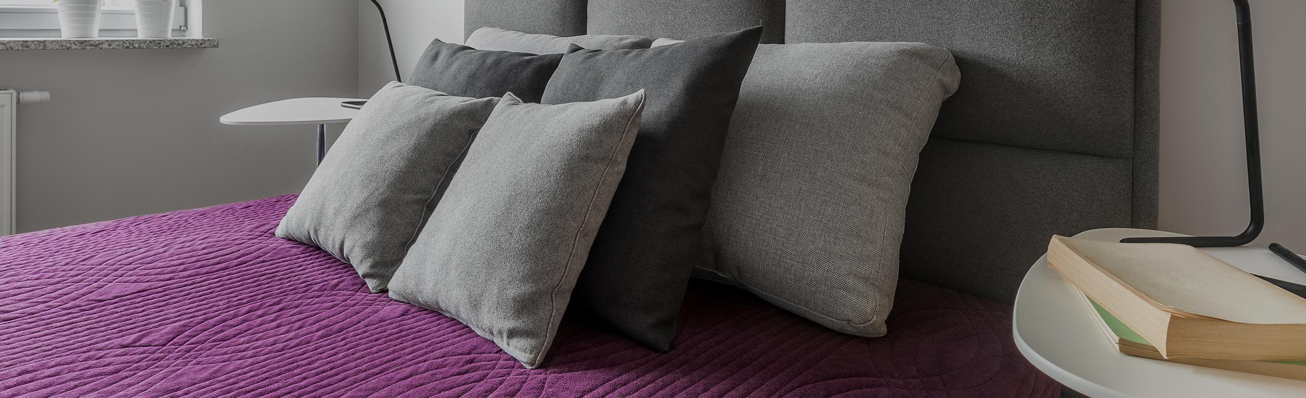 Box spring bed in a hotel room.