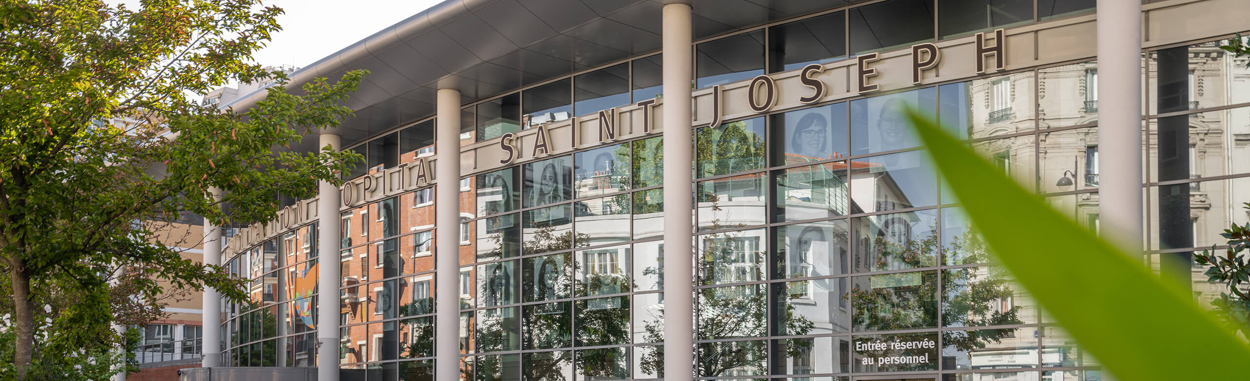 Entrance area with glass front and columns of the Saint-Joseph hospital in Paris.